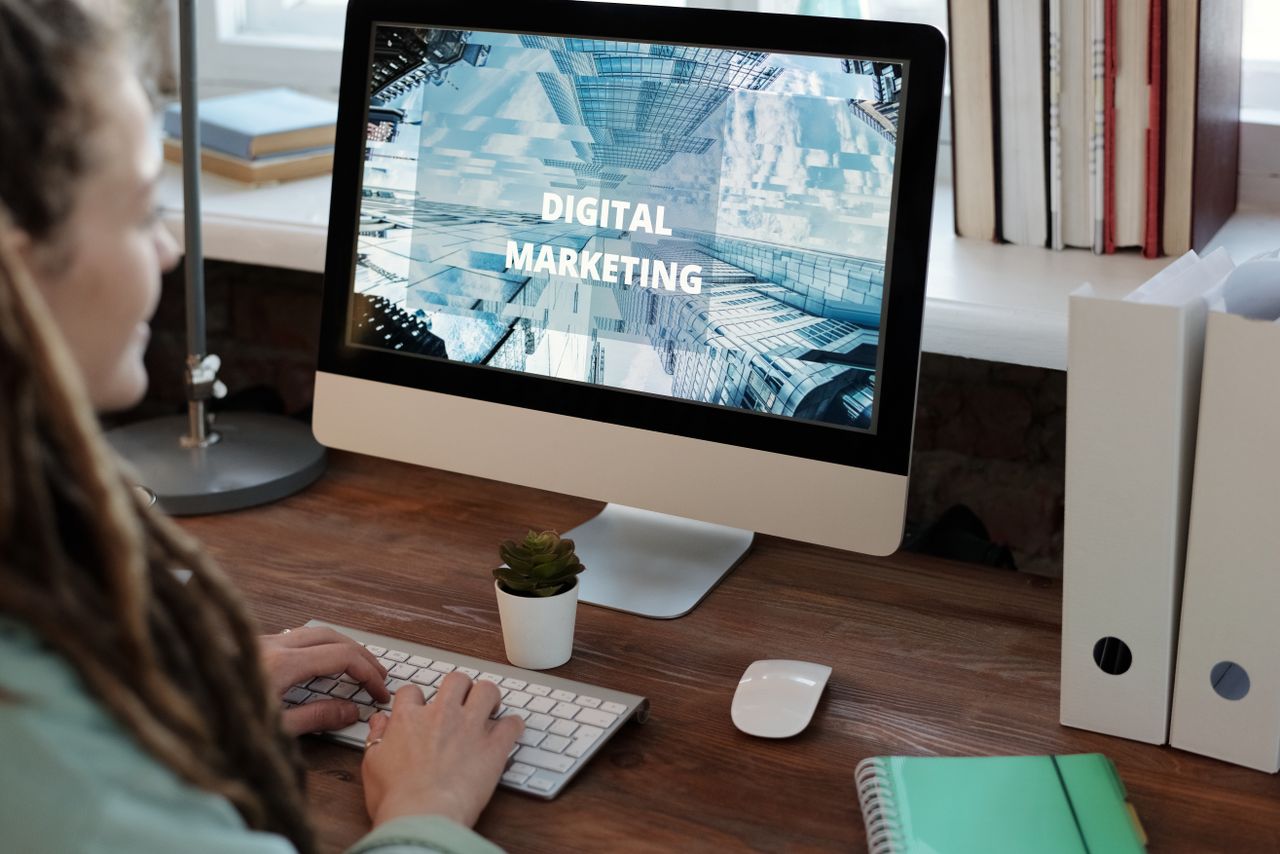 Services Close-up of a woman working on a digital marketing project in a home office setting.